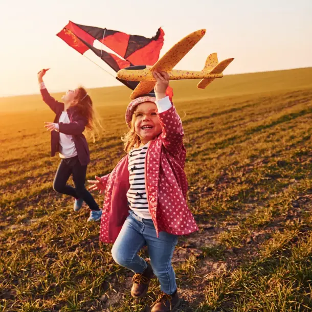 pcs image1 children running and playing in a field holding a model plane and a kite