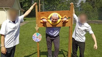 Headteacher Richard in the stocks